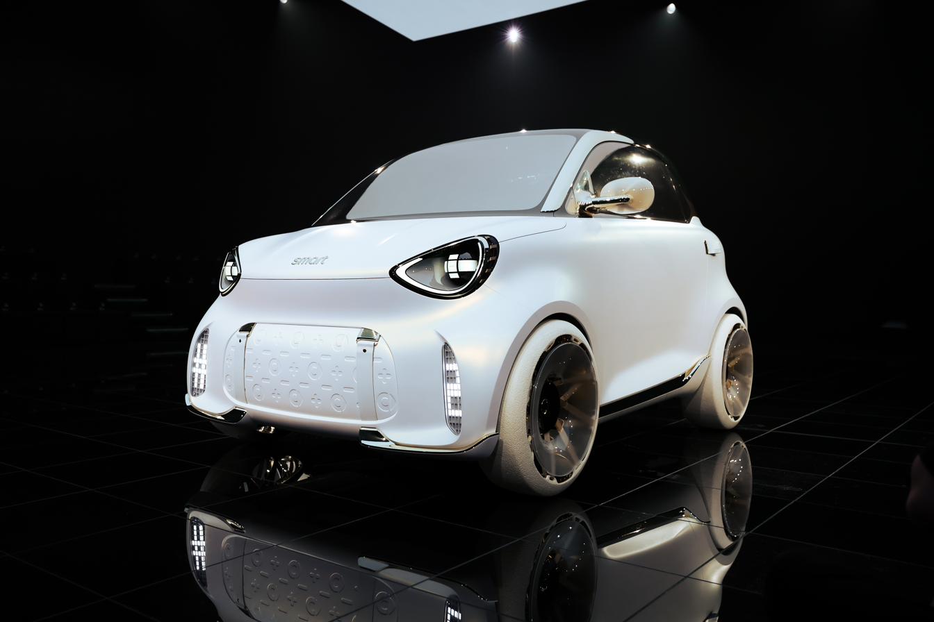 smart #2, three-quarter front view, on the mirrored floor of the reveal stage